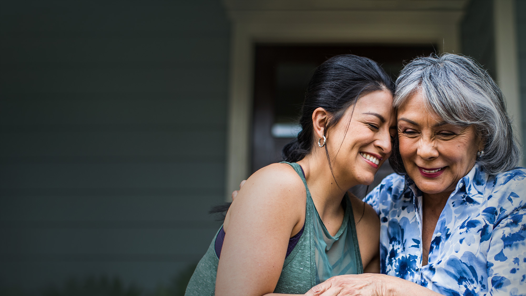 Mother and daughter smiling and laughing. 