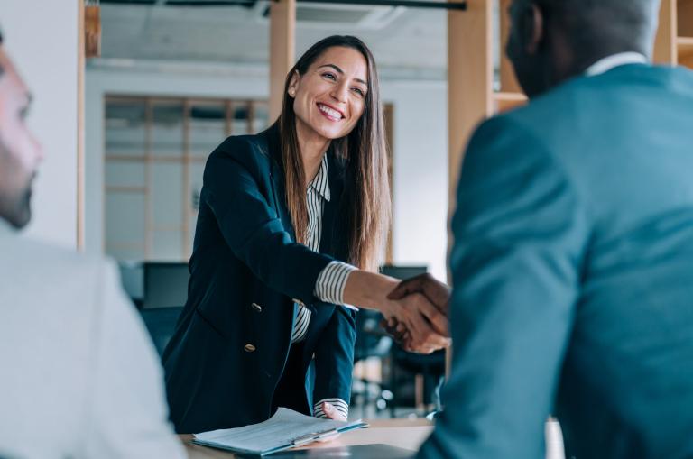 Woman shaking hand with a man. 