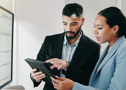 Man and woman looking at iPad. 