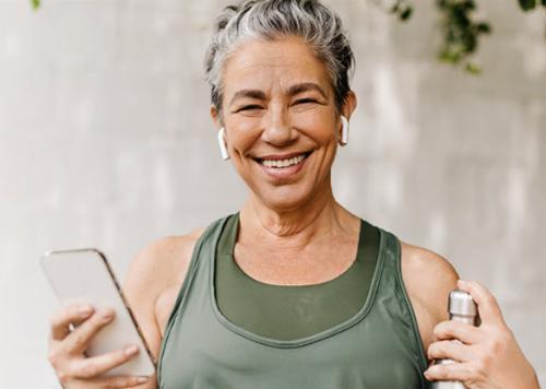 Woman smiling with phone. 